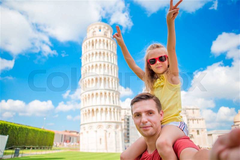 Pisa - travel to famous places in Europe, family portrait in background the Leaning Tower in Pisa, Italy, stock photo
