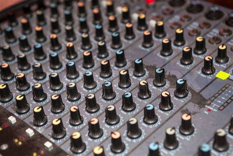 Old dusty audio studio mixer knobs panel. Shallow depth of field, stock photo