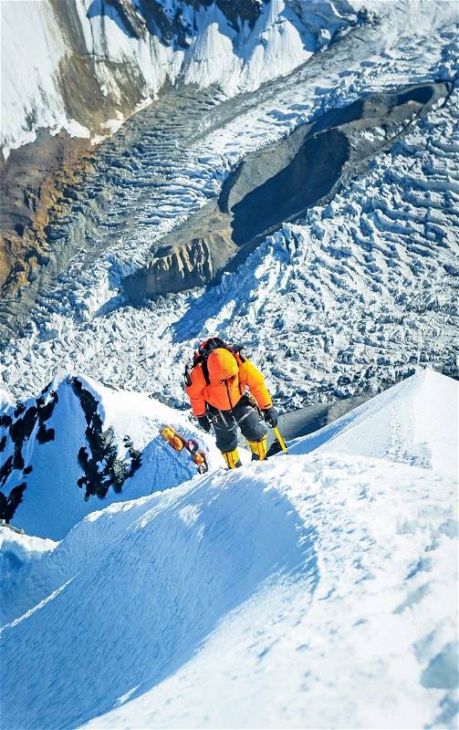 The climber reaching the summit in Nepal. Extreme sport concept, stock photo