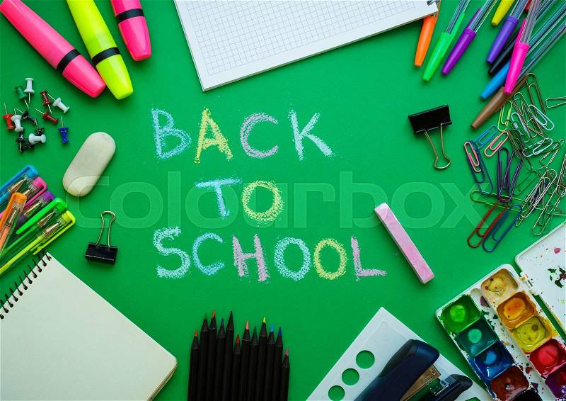 School supplies on blackboard background ready for your design - concept back to school, stock photo