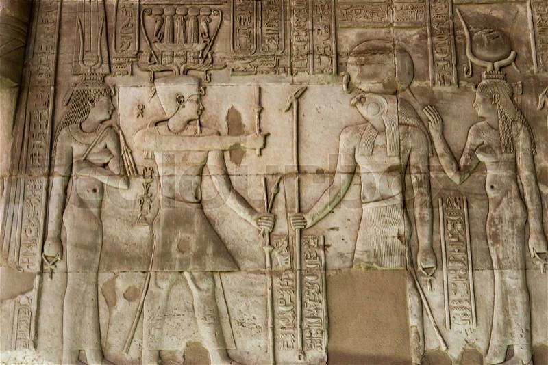 Hieroglyphic carvings on the exterior walls of egyptian temple, stock photo