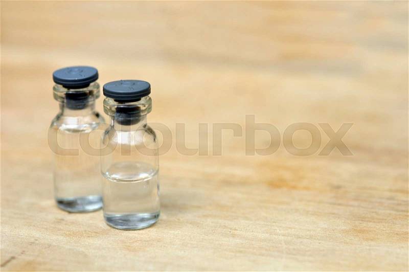 Medical vials for injection on wood table background, stock photo