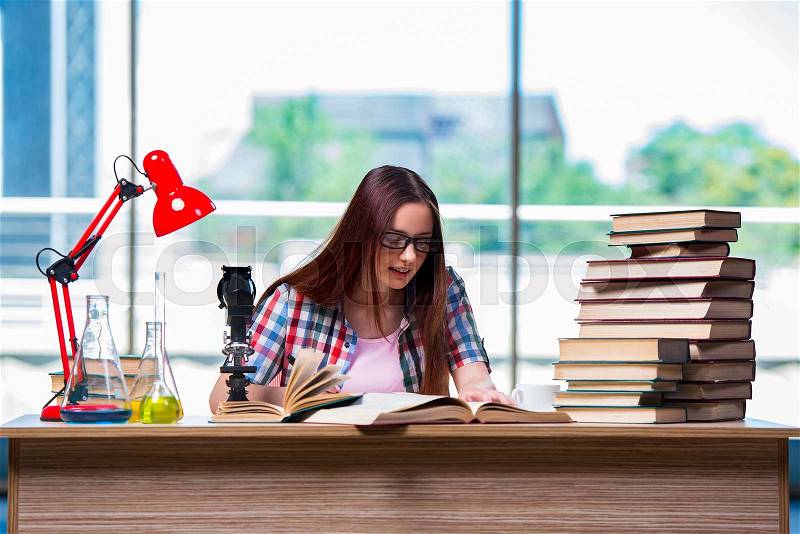 The female student preparing for chemistry exams, stock photo