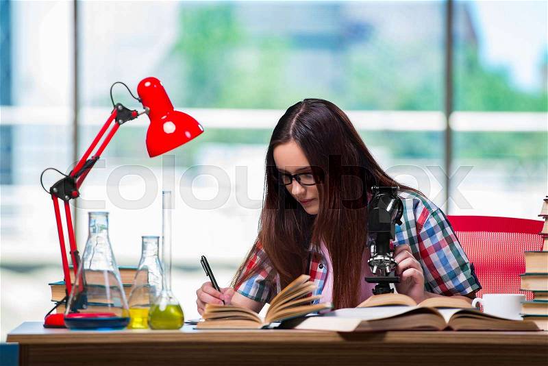 The female student preparing for chemistry exams, stock photo
