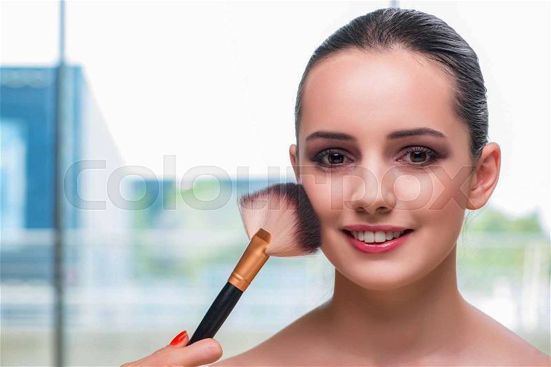 The beautiful woman during make-up cosmetics session, stock photo