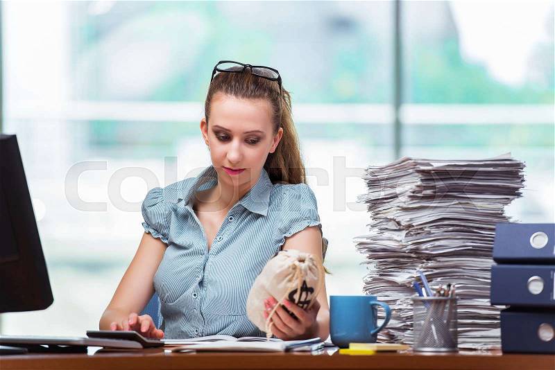 The businesswoman with money sacks in the office, stock photo