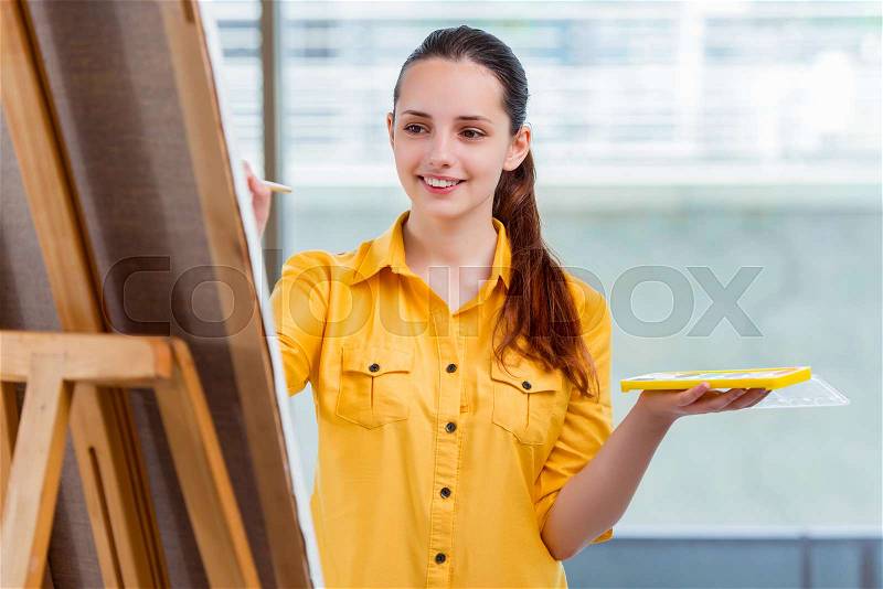 The young student artist drawing pictures in studio, stock photo