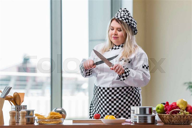 The young chef cook working in the kitchen, stock photo