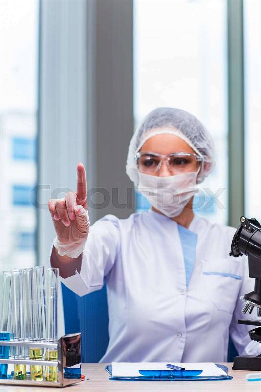 The young student working with chemical solutions in lab, stock photo