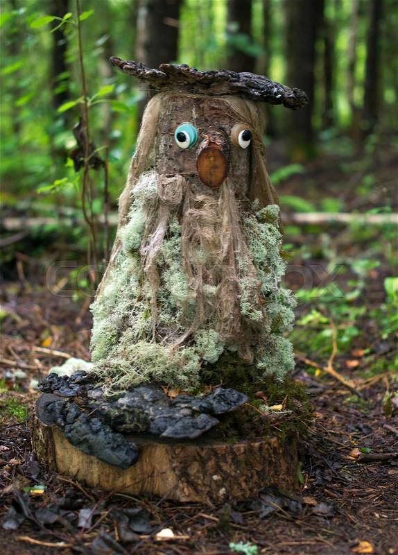 Funny forest dweller made from wood, stock photo