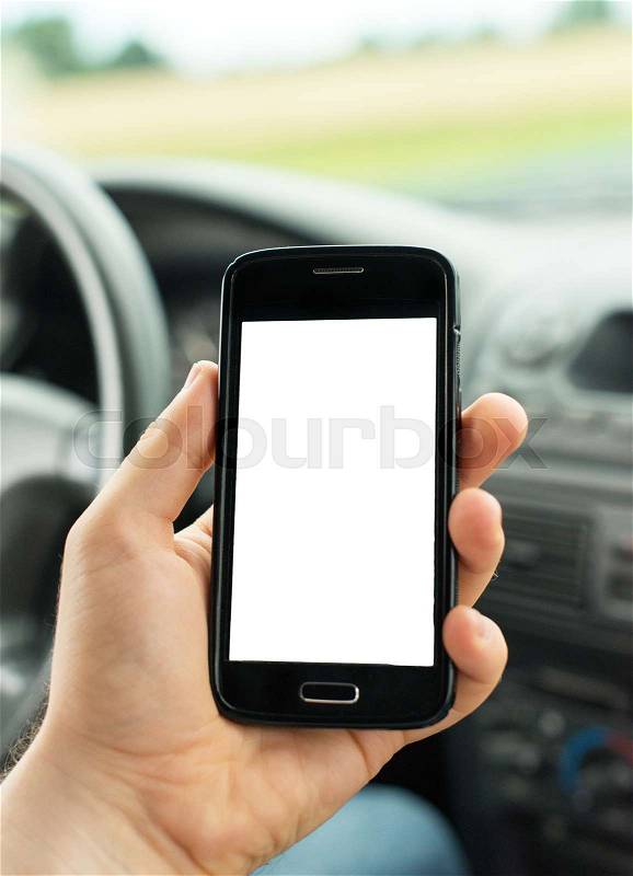 Man using mobile phone in car. Blank screen for your text, stock photo