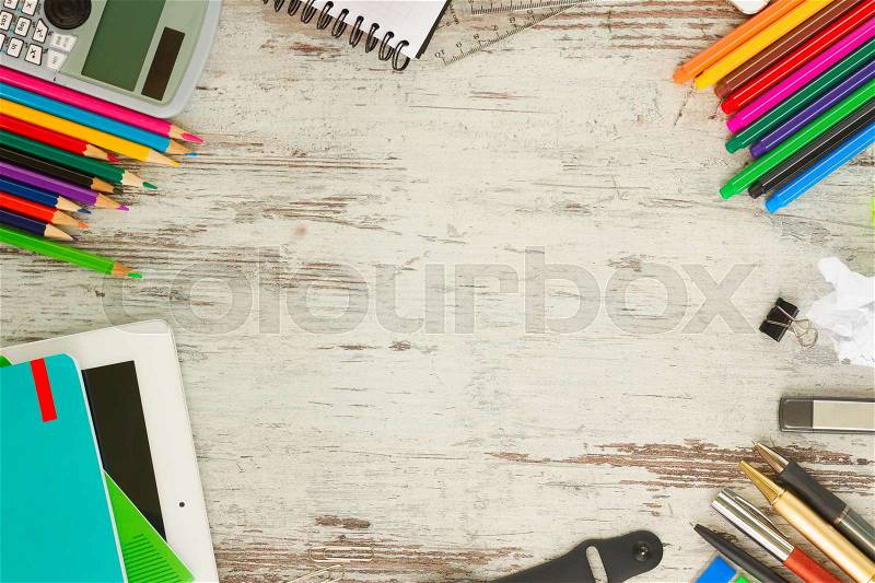 Back to school frame with school supplies on aged wooden table, stock photo