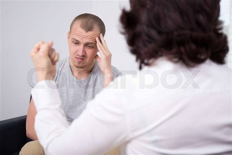 Female boss screaming at young bad worker, stock photo