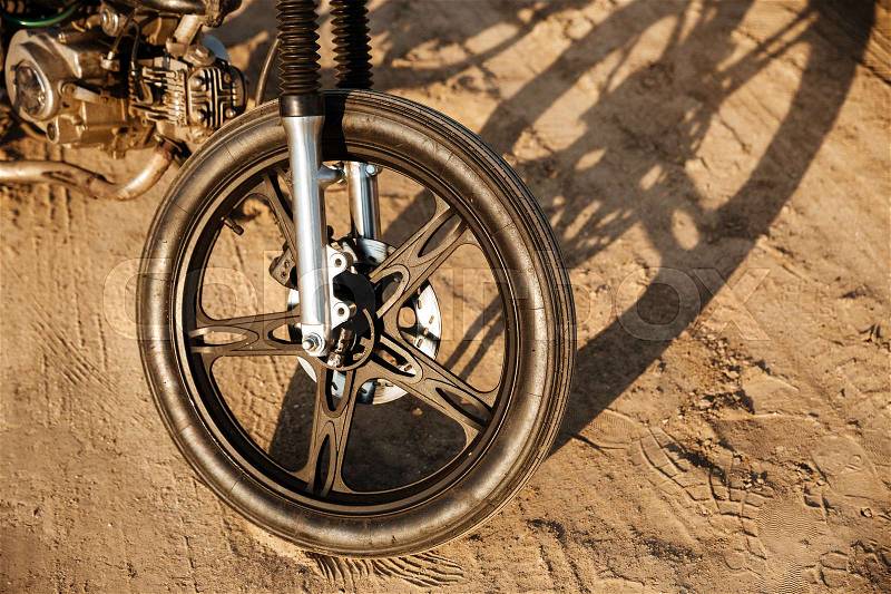 Close up of motorcycle wheel at the desert, stock photo