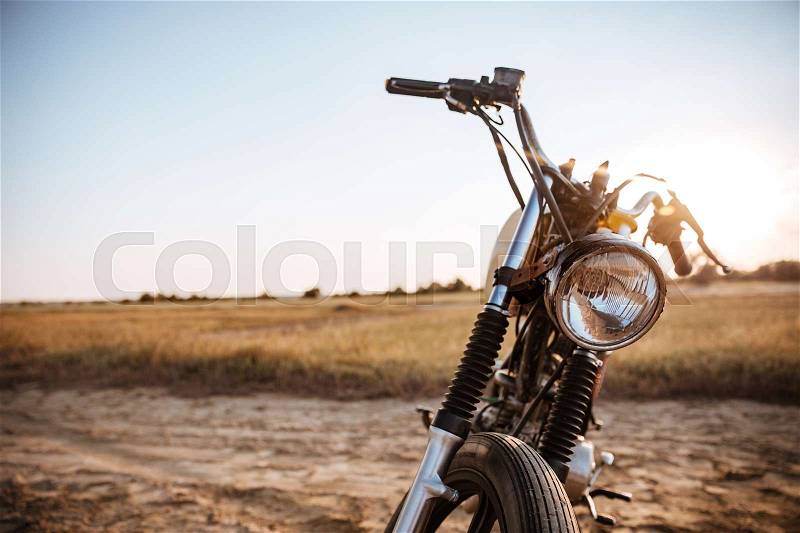 Close-up view on retro motorcycle headlights on the desert background, stock photo