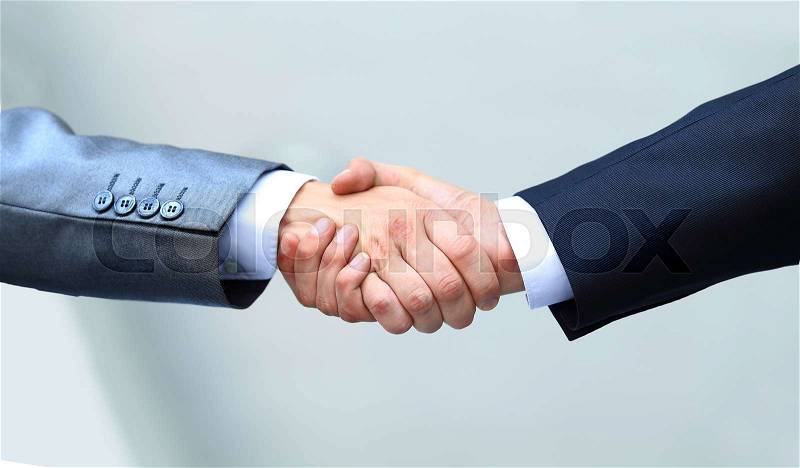 Shaking hands in the office at the beginning of the working day, stock photo