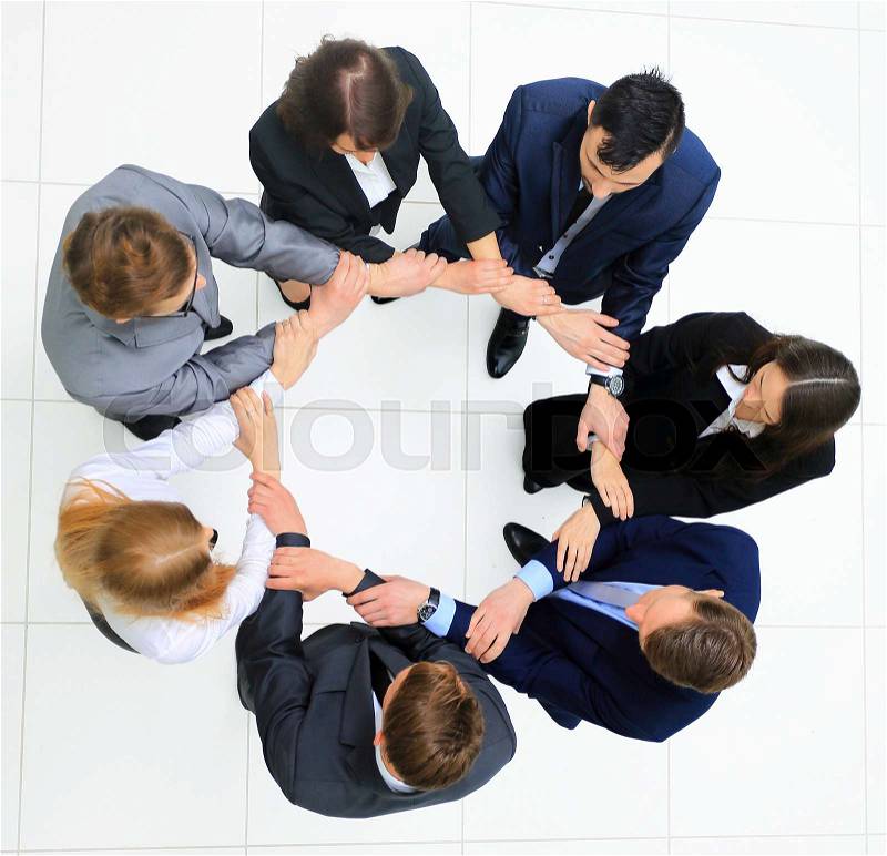 Top view of business people with their hands together in a circle, stock photo