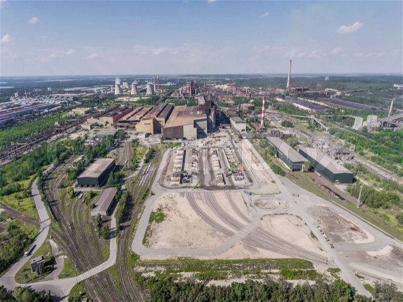 Steel factory with smokestacks at sunny day.Metallurgical plant. steelworks, iron works. Heavy industry in Europe.Air pollution from smokestacks, ecology problems. Industrial landscape.View from above, stock photo