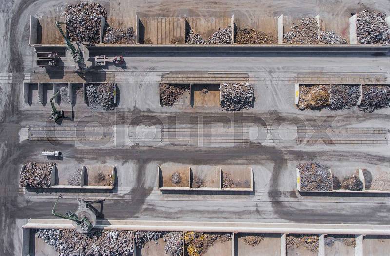 Iron raw materials recycling pile, work machines. Metal waste junkyard. View from above, stock photo