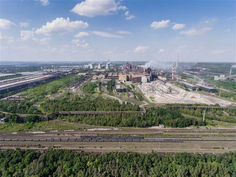 Steel factory with smokestacks at sunny day.Metallurgical plant. steelworks, iron works. Heavy industry in Europe.Air pollution from smokestacks, ecology problems. Industrial landscape.View from above, stock photo