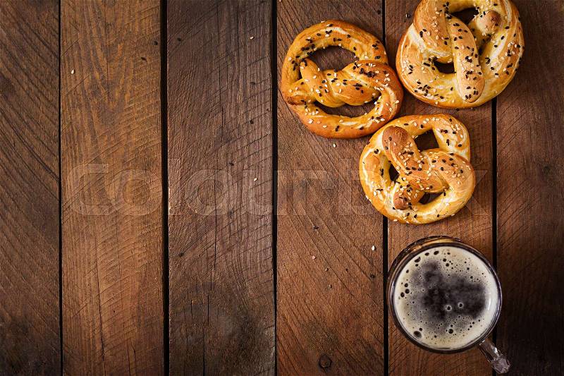 Oktoberfest salted soft pretzels and beer from Germany on wooden background. Top view, stock photo