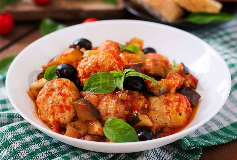 Juicy meatballs of turkey meat with vegetables (zucchini, eggplant, olive, tomato), stock photo