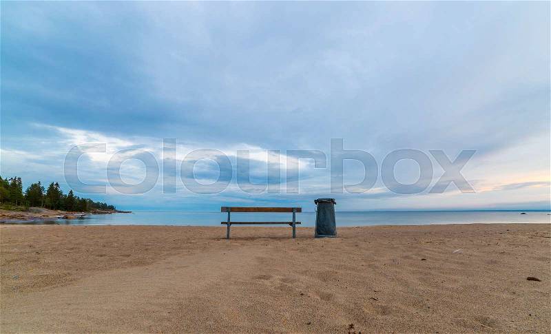 Bench and Trash Can on Beach by Ocean, stock photo