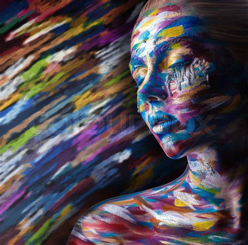 Beautiful woman with colorful makeup and body art on a colorful background, stock photo