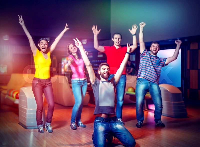 Happy team celebrating the victory in bowling, stock photo