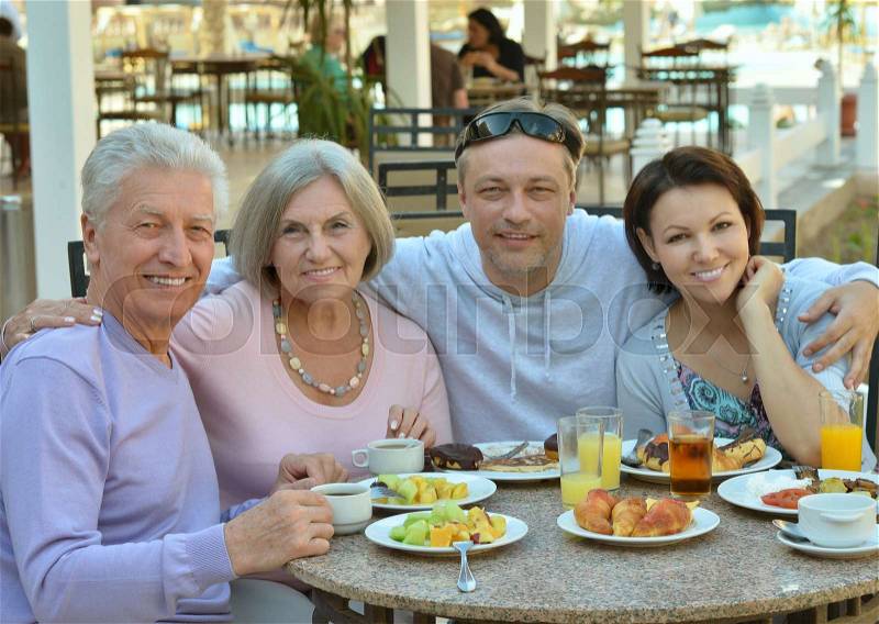 Happy family at breakfast on tropical resort, stock photo