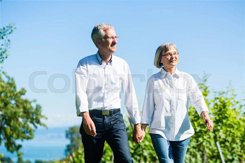 Senior woman and man having walk in summer, stock photo