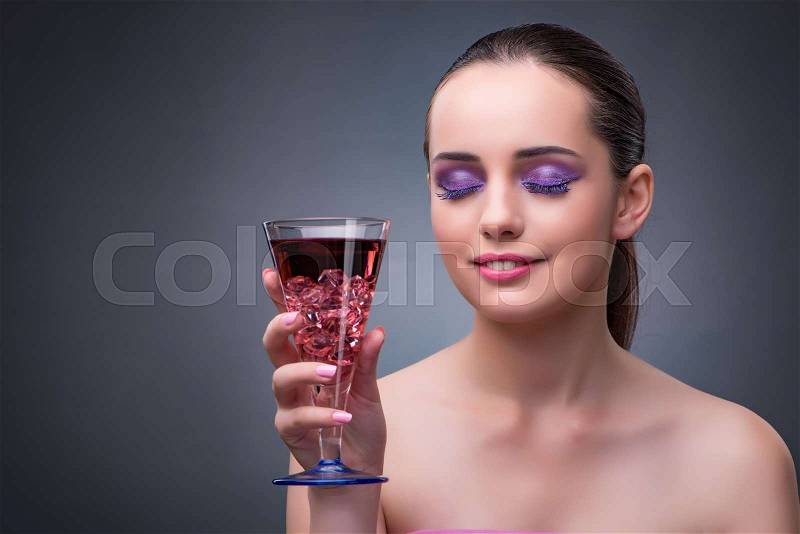 Nice woman drinking red cocktail, stock photo