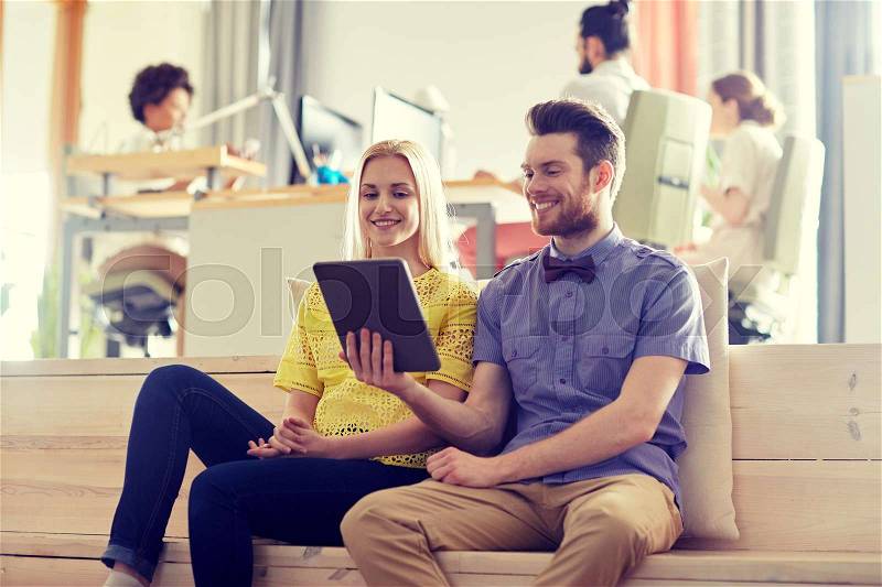 Business, technology, startup and people concept - happy creative team with tablet pc computer in office, stock photo