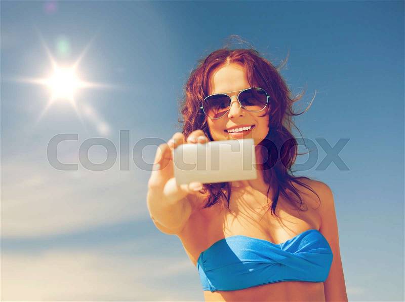 Picture of happy woman with phone on the beach, stock photo