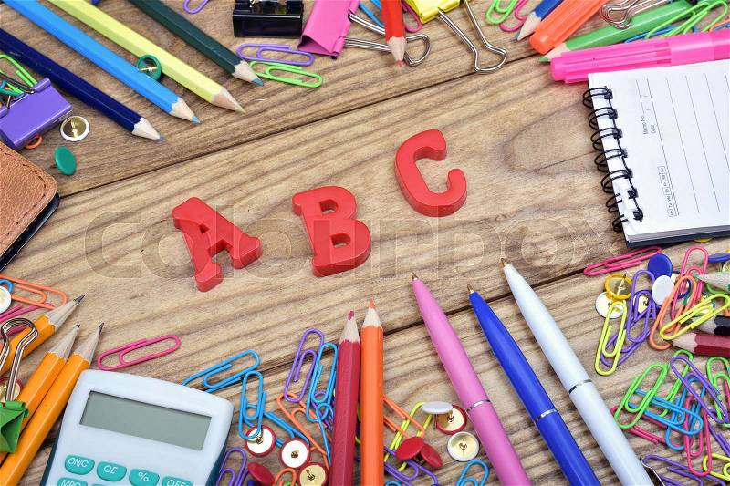 ABC word and office tools on wooden table, stock photo
