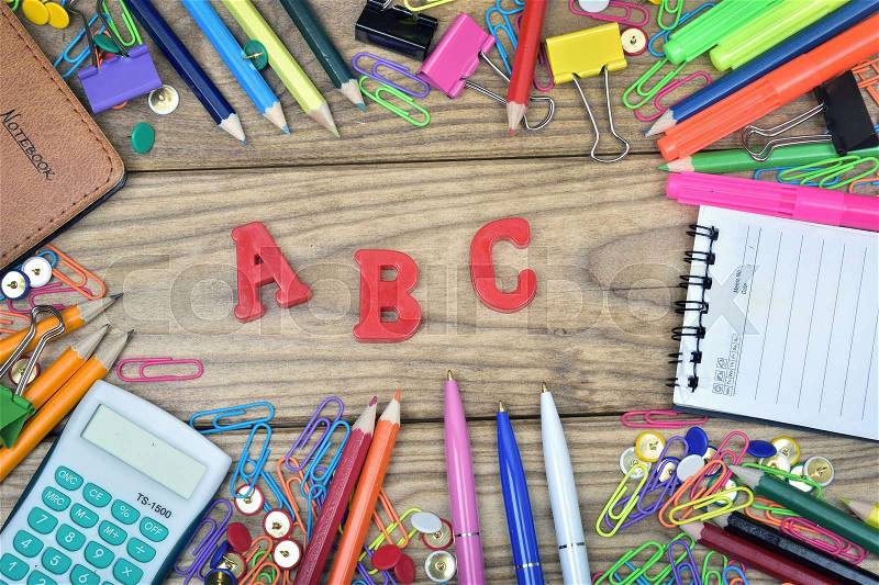 ABC word and office tools on wooden table, stock photo