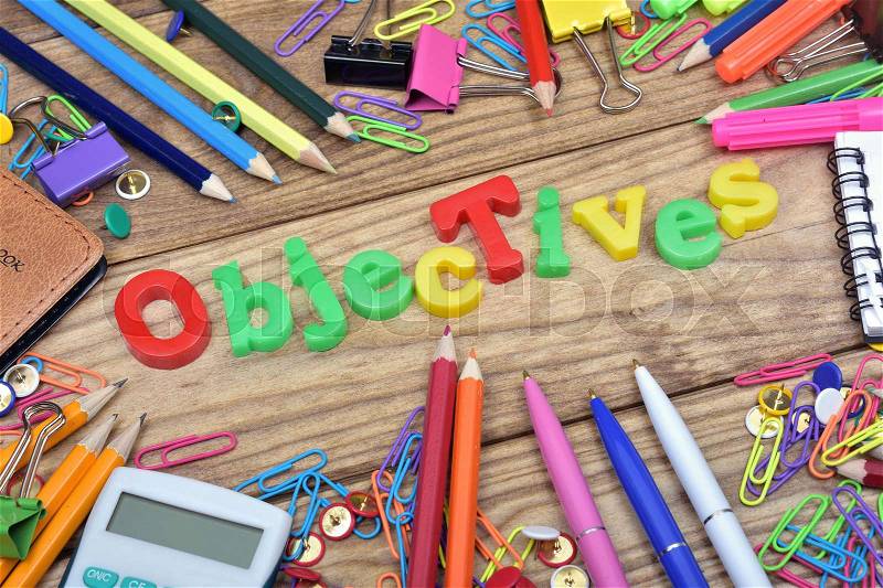 Objectives word and office tools on wooden table, stock photo