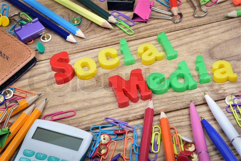 Social Media word and office tools on wooden table, stock photo