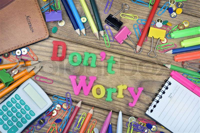 Don\'t Worry word and office tools on wooden table, stock photo