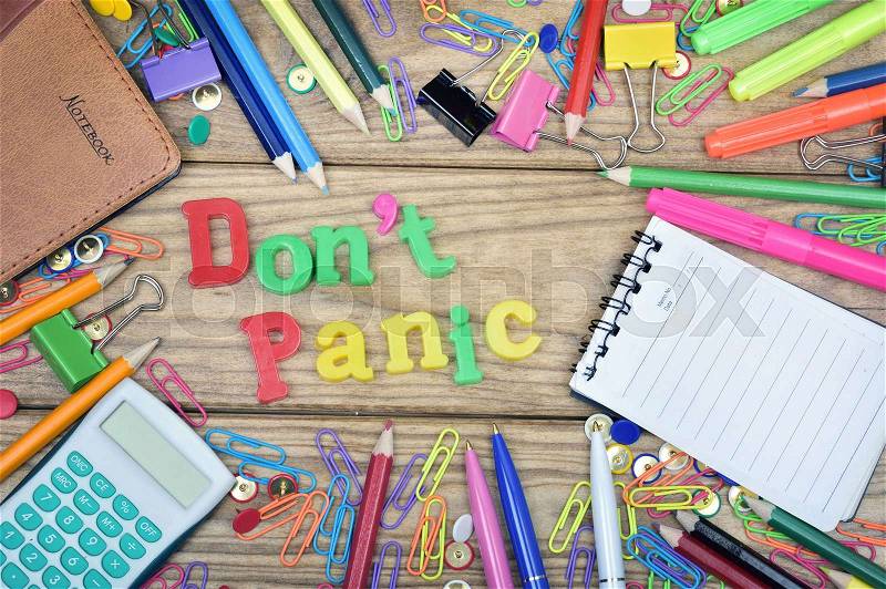 Don\'t panic word and office tools on wooden table, stock photo