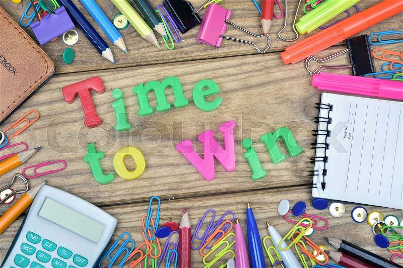 Time to Win word and office tools on wooden table, stock photo