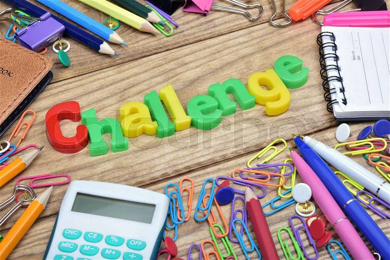Challenge word and office tools on wooden table, stock photo