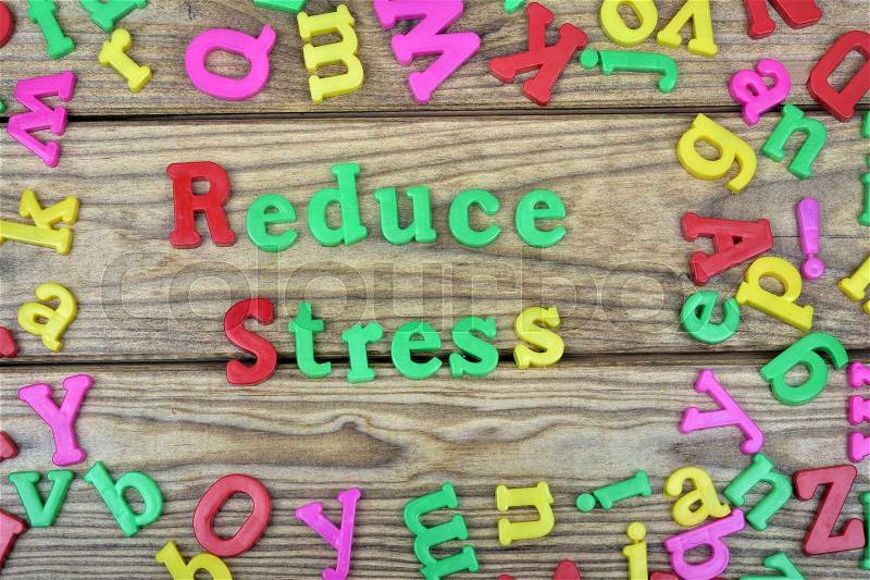 Reduce Stress word on wooden table, stock photo