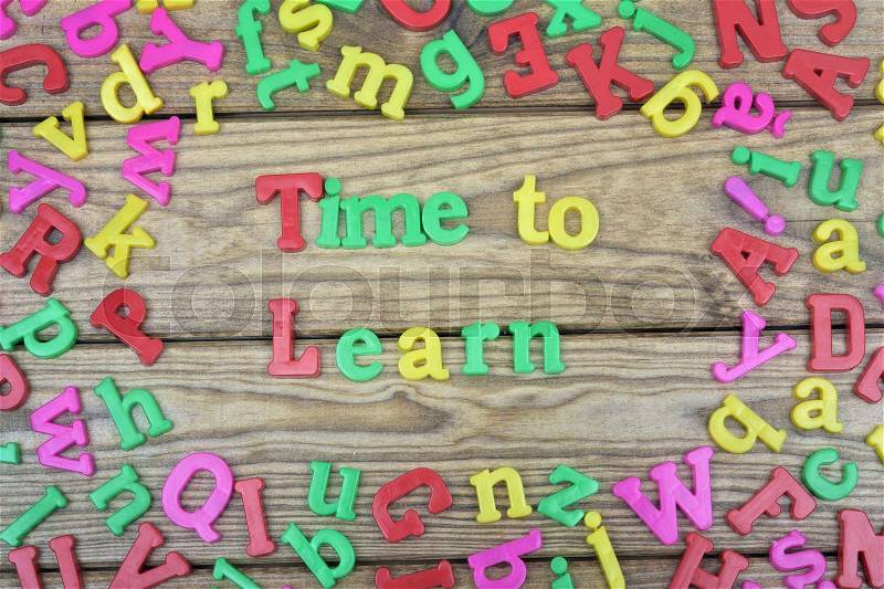 Time to learn word on wooden table, stock photo