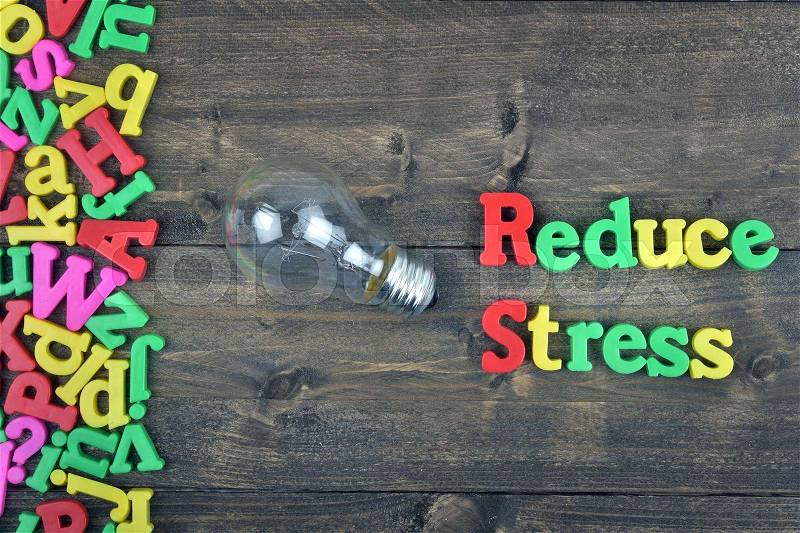 Reduce stress word on wooden table, stock photo