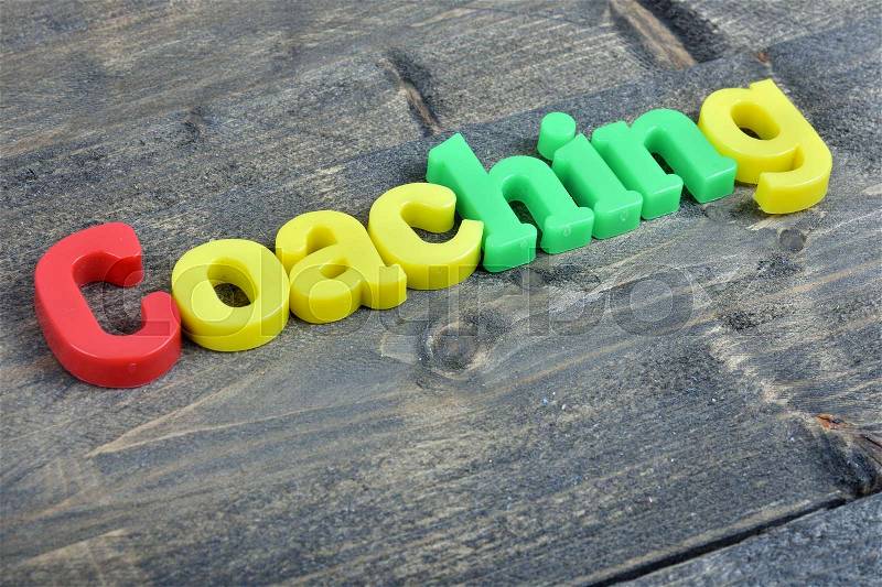 Coaching word on wooden table, stock photo