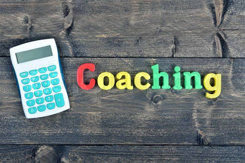 Coaching word on wooden table, stock photo