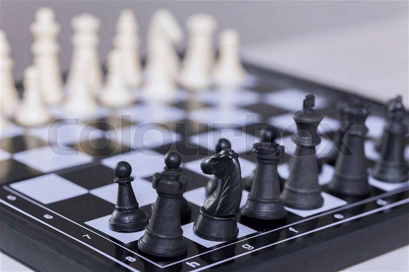 Chess pieces lining up on Chess board (Focus on the front pieces), stock photo