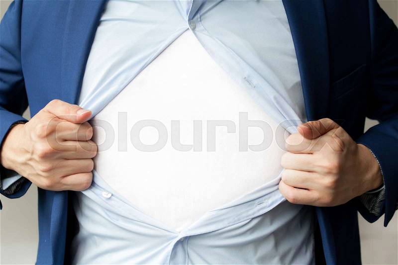 Businessman in suit tearing shirt with blank white copy space in the middle, stock photo