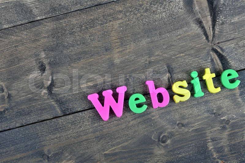Website word on wooden table, stock photo